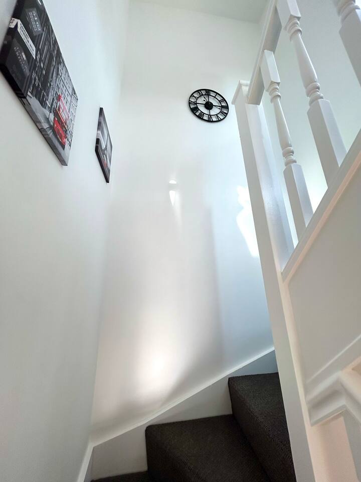 Relaxed living room with TV, couch, and dining area.