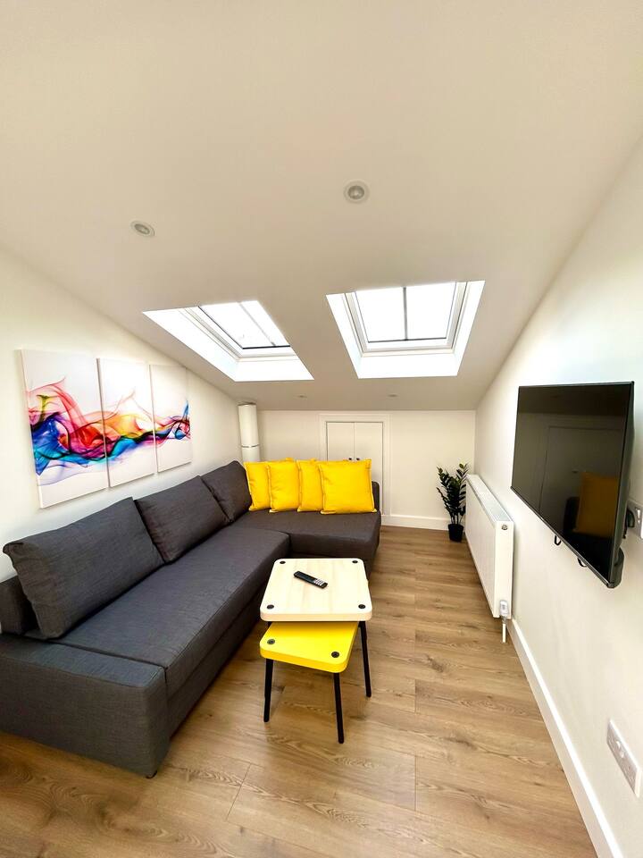 Bright and open living space with skylights and kitchen.