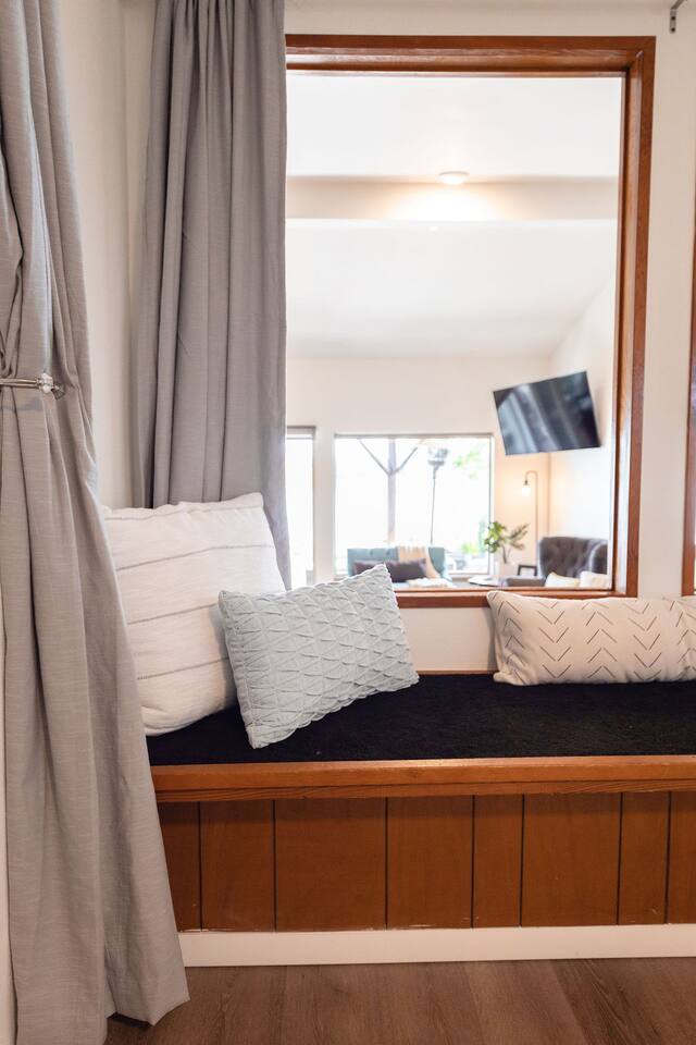 Master bed sits up above the living space and looks out onto the lake