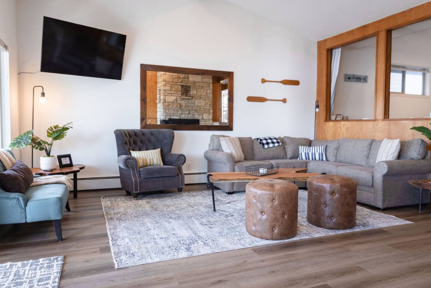 Relax in the spacious living room with modern furnishings, smart TV, and panoramic lake views.