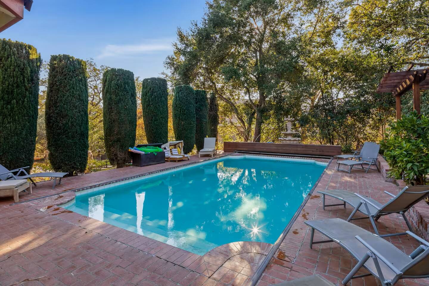 A secluded poolside escape surrounded by lush greenery. Perfect for a refreshing swim or soaking up the sun.