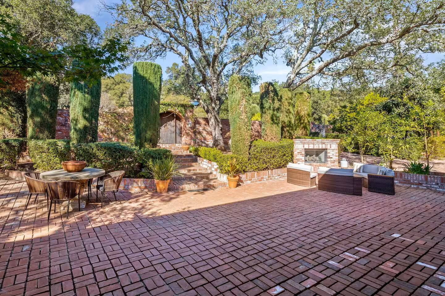 Enjoy gathering around the outdoor fireplace for some cozy 'tea' time.