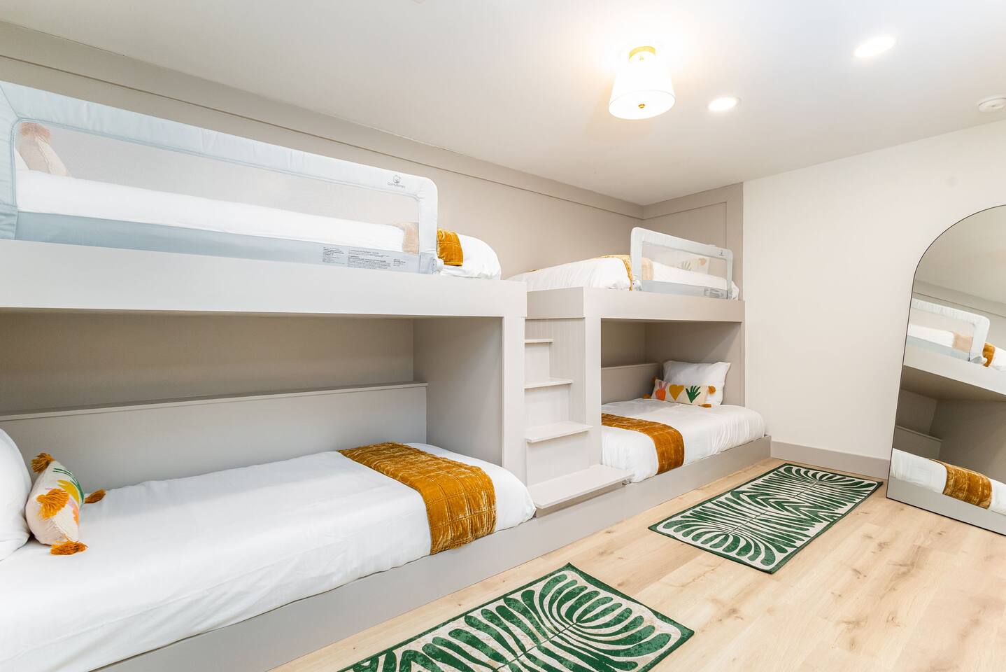 Bunk room with built-in bunk beds and a green patterned rug
