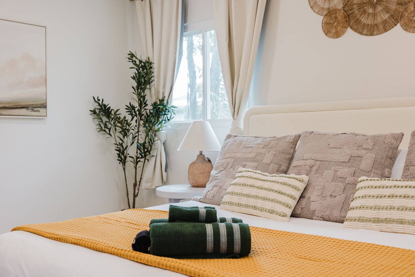 Primary bedroom with a king bed and a mustard throw