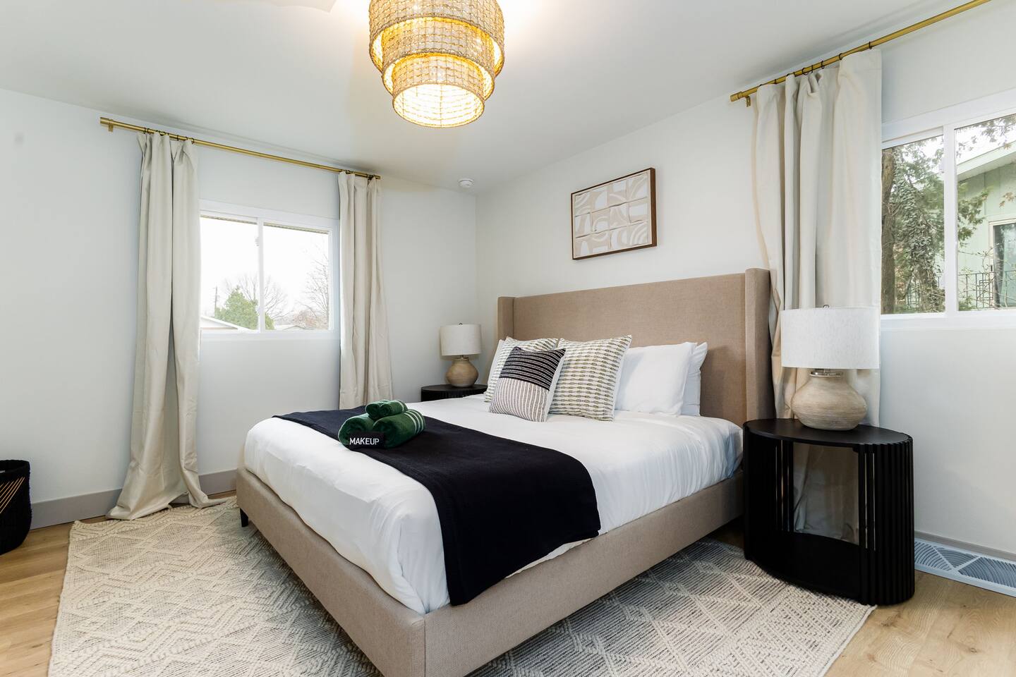 Second king bedroom with a black throw and soft lighting
