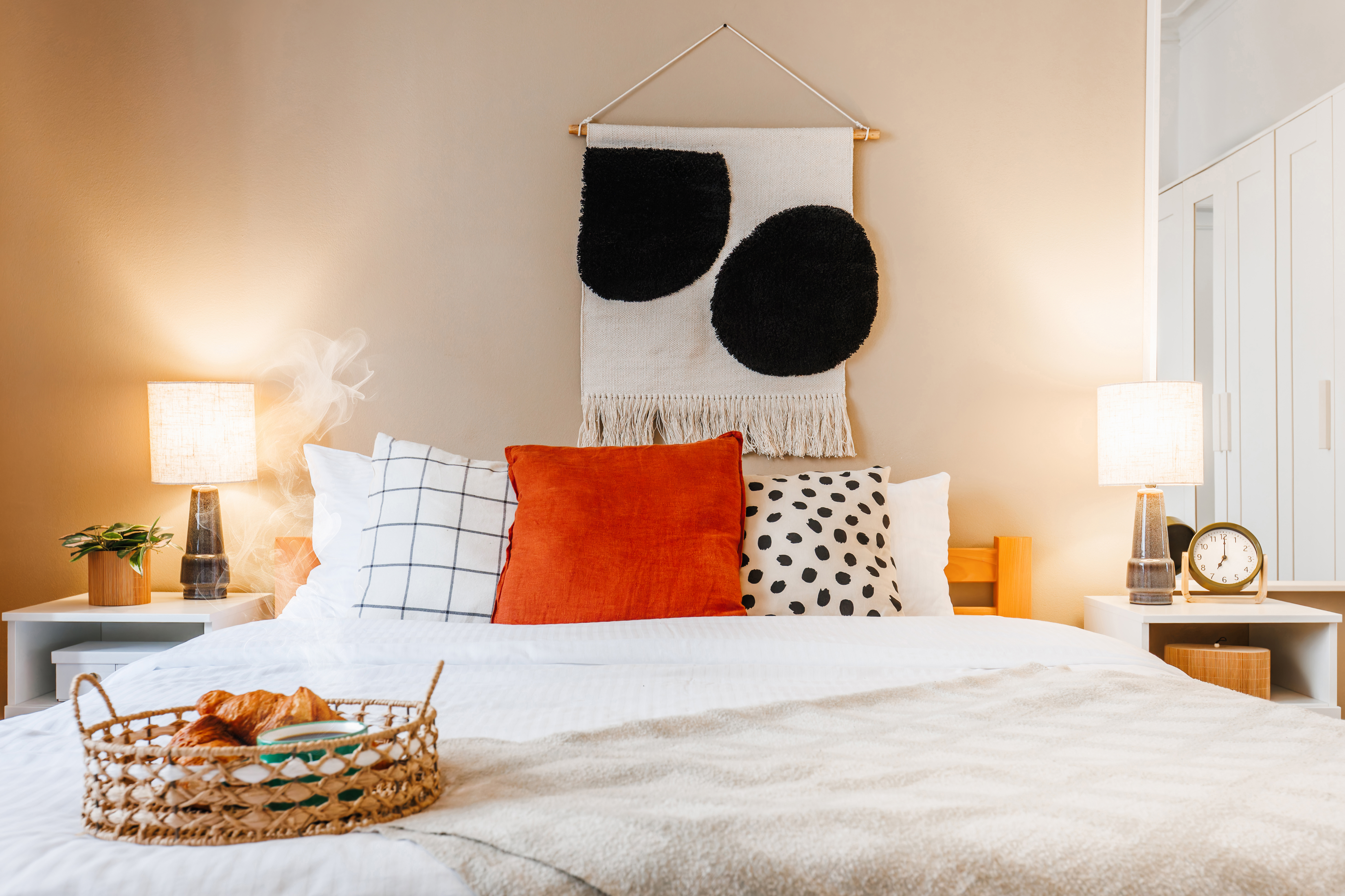 Cozy designer bedroom with warm lighting and a breakfast-in-bed touch