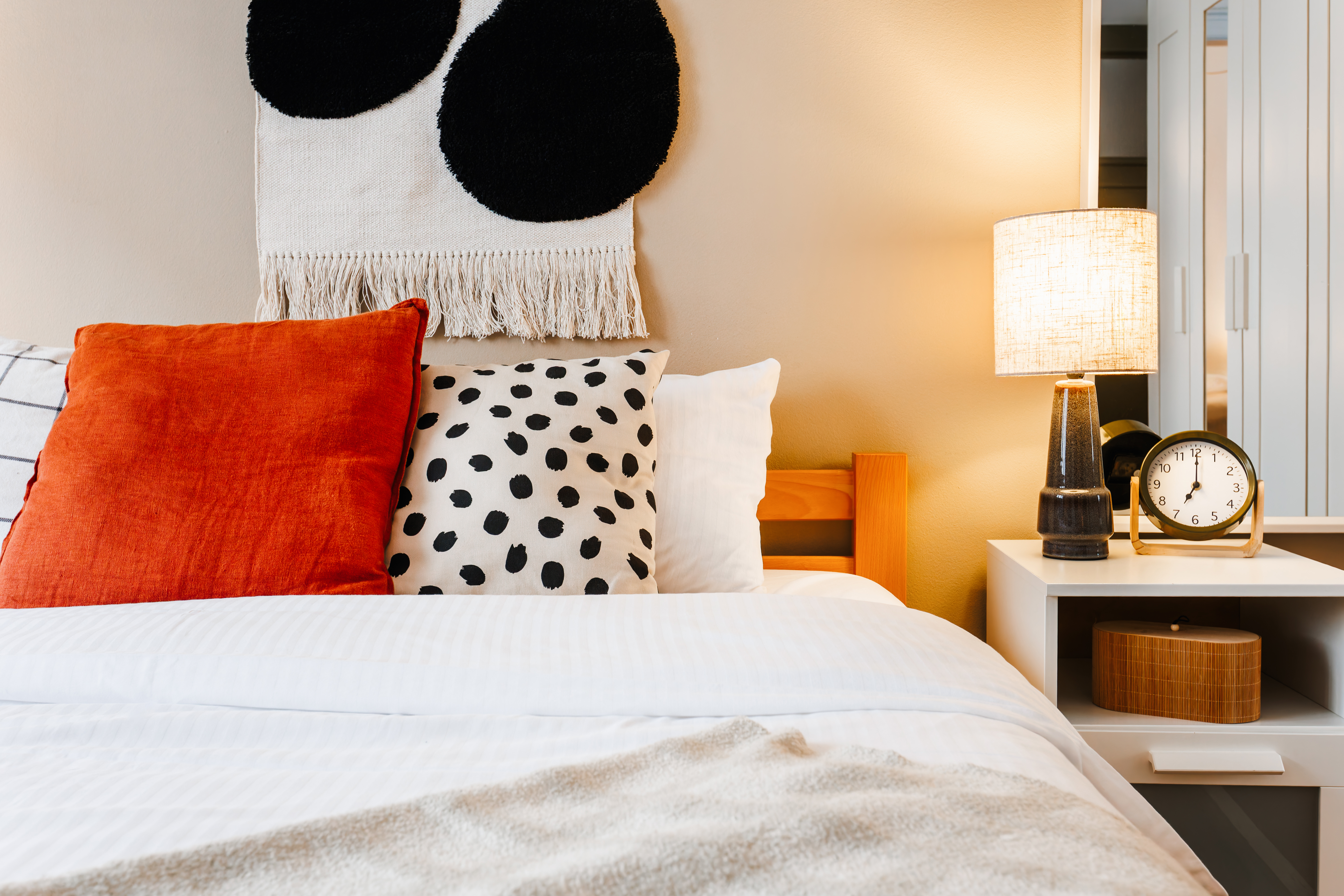 Cozy, stylish bedroom with crisp linens and warm modern accents