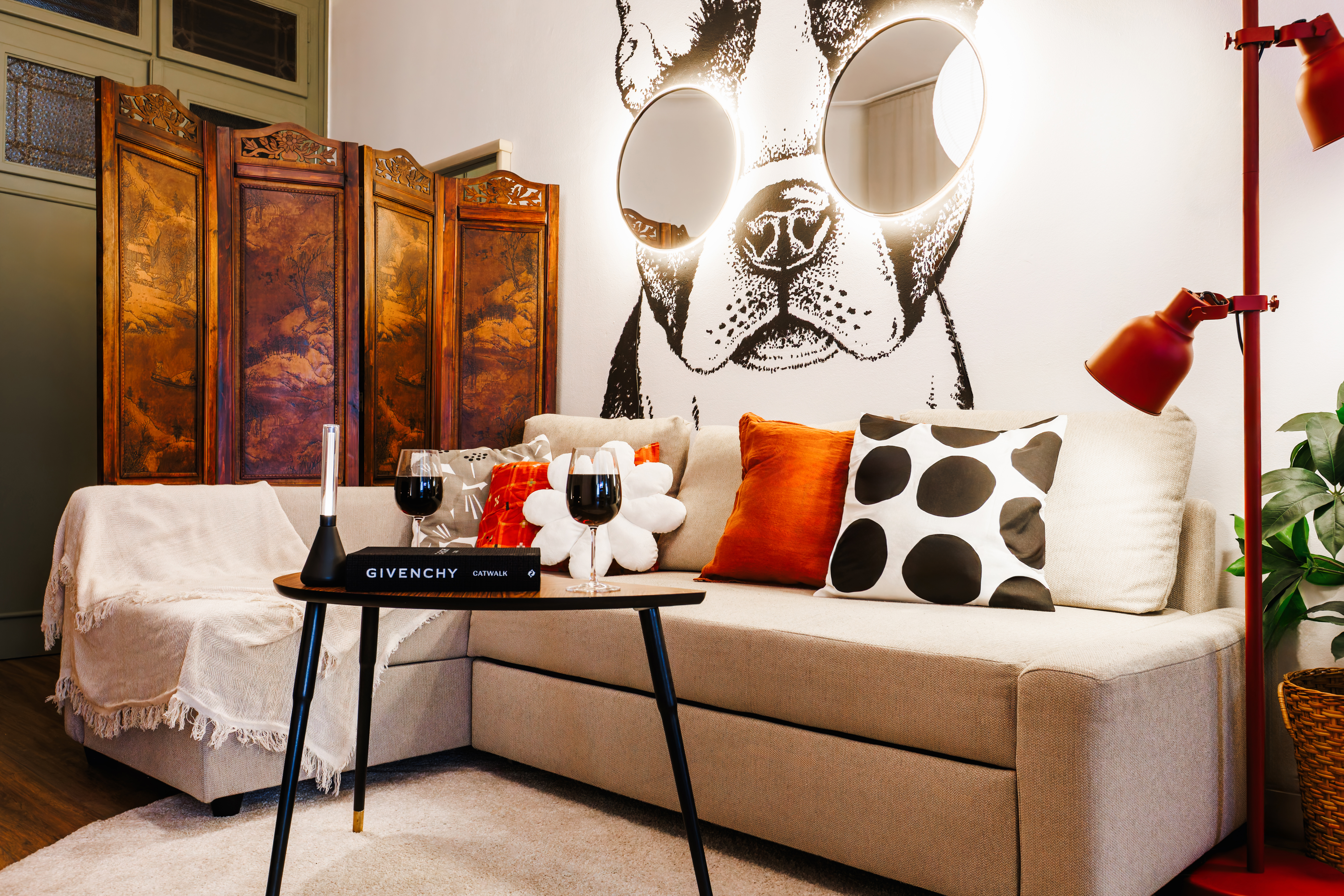 Chic lounge with designer touches, cozy seating, and playful statement art