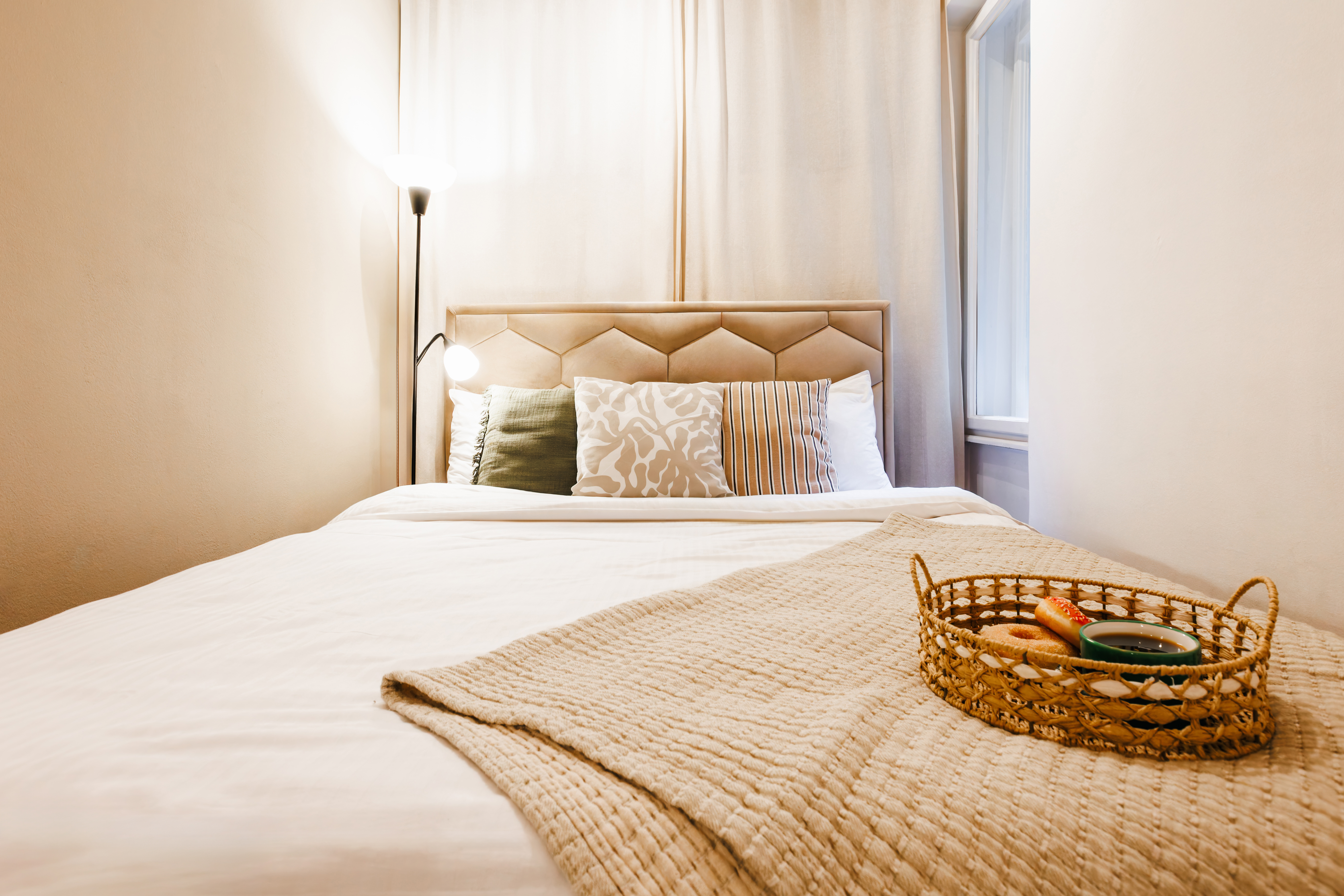 Cozy bedroom retreat with soft linens, warm lighting, and inviting style