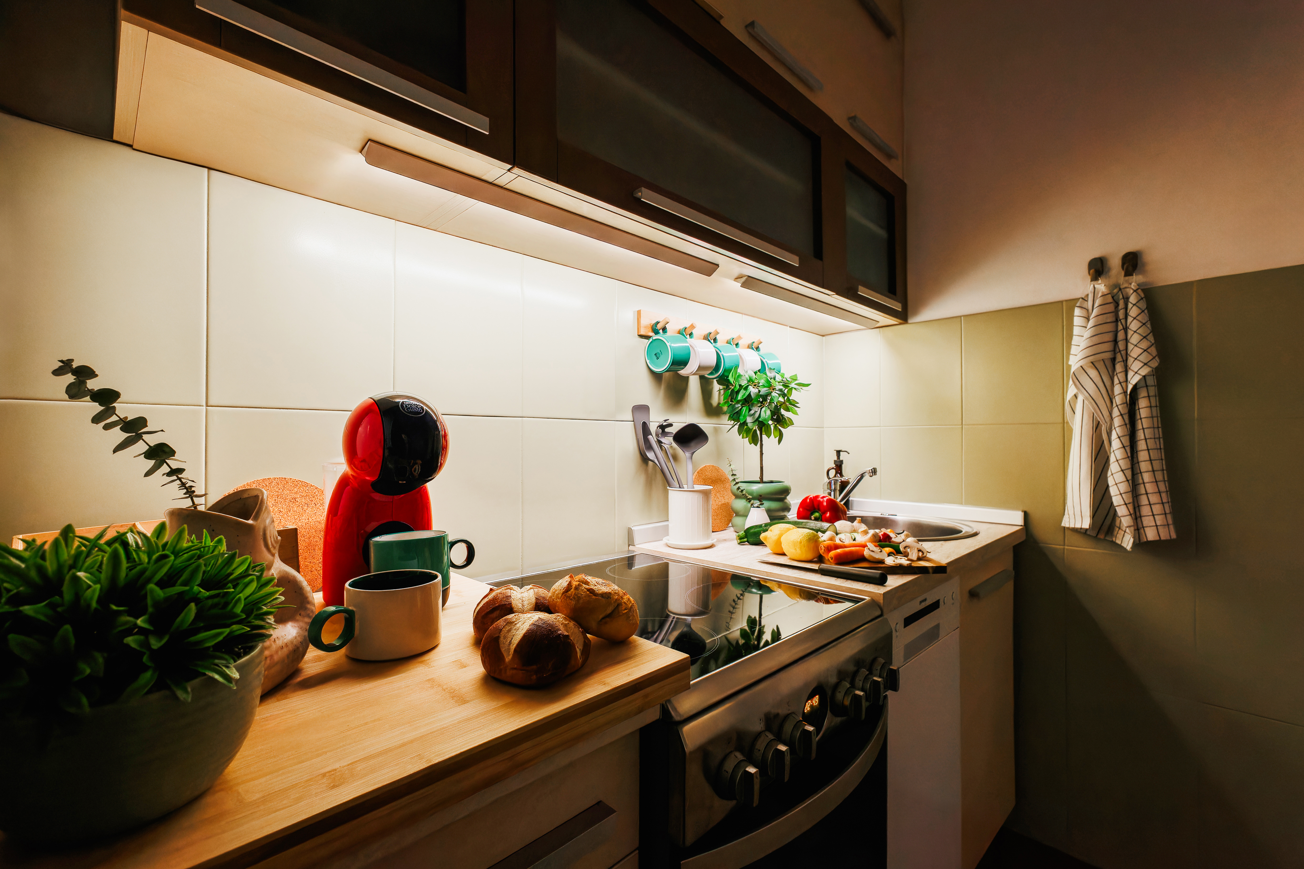 Cozy modern kitchen with warm lighting, coffee station, and stylish touches