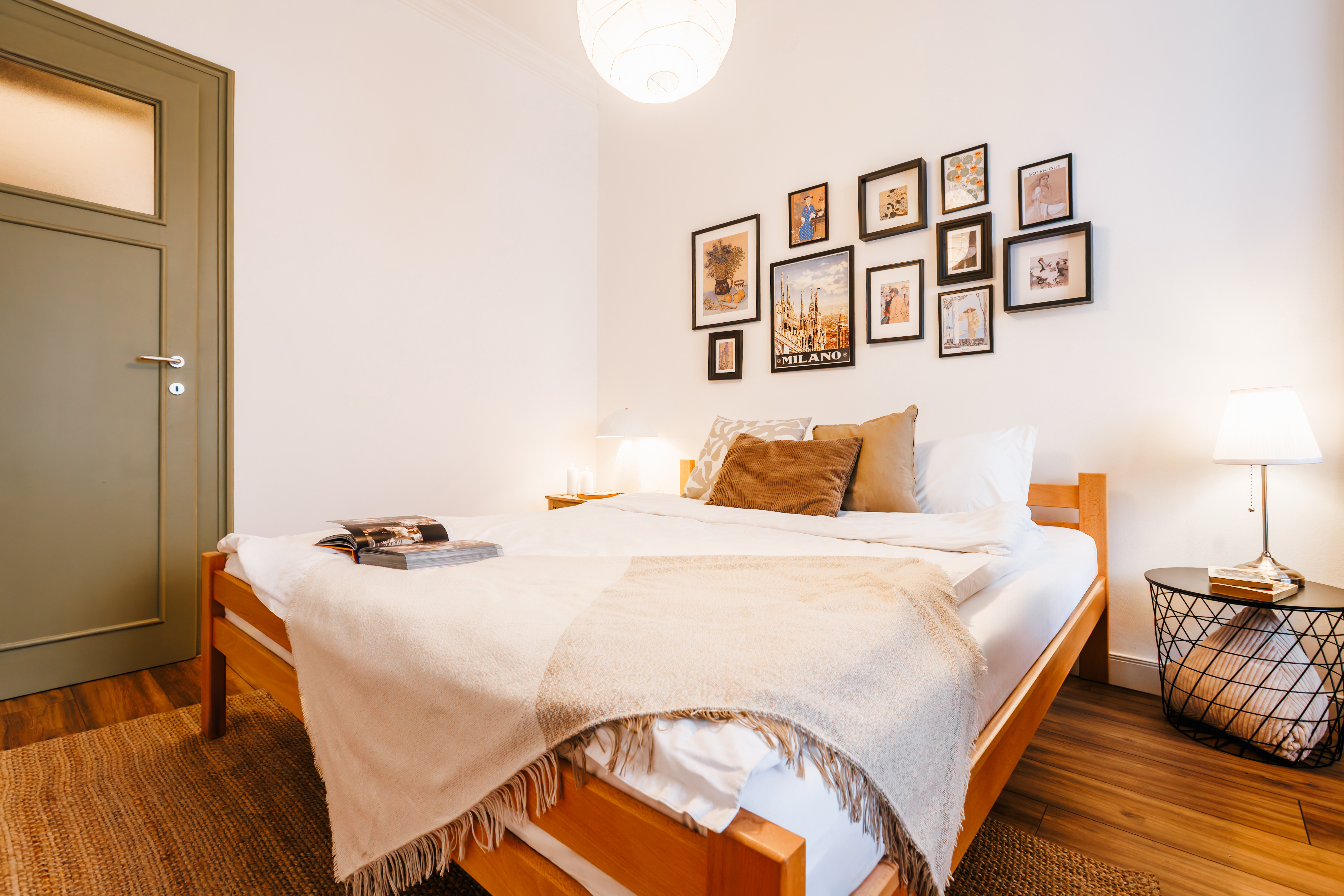 Cozy, art-filled bedroom with warm wood accents and soft ambient lighting