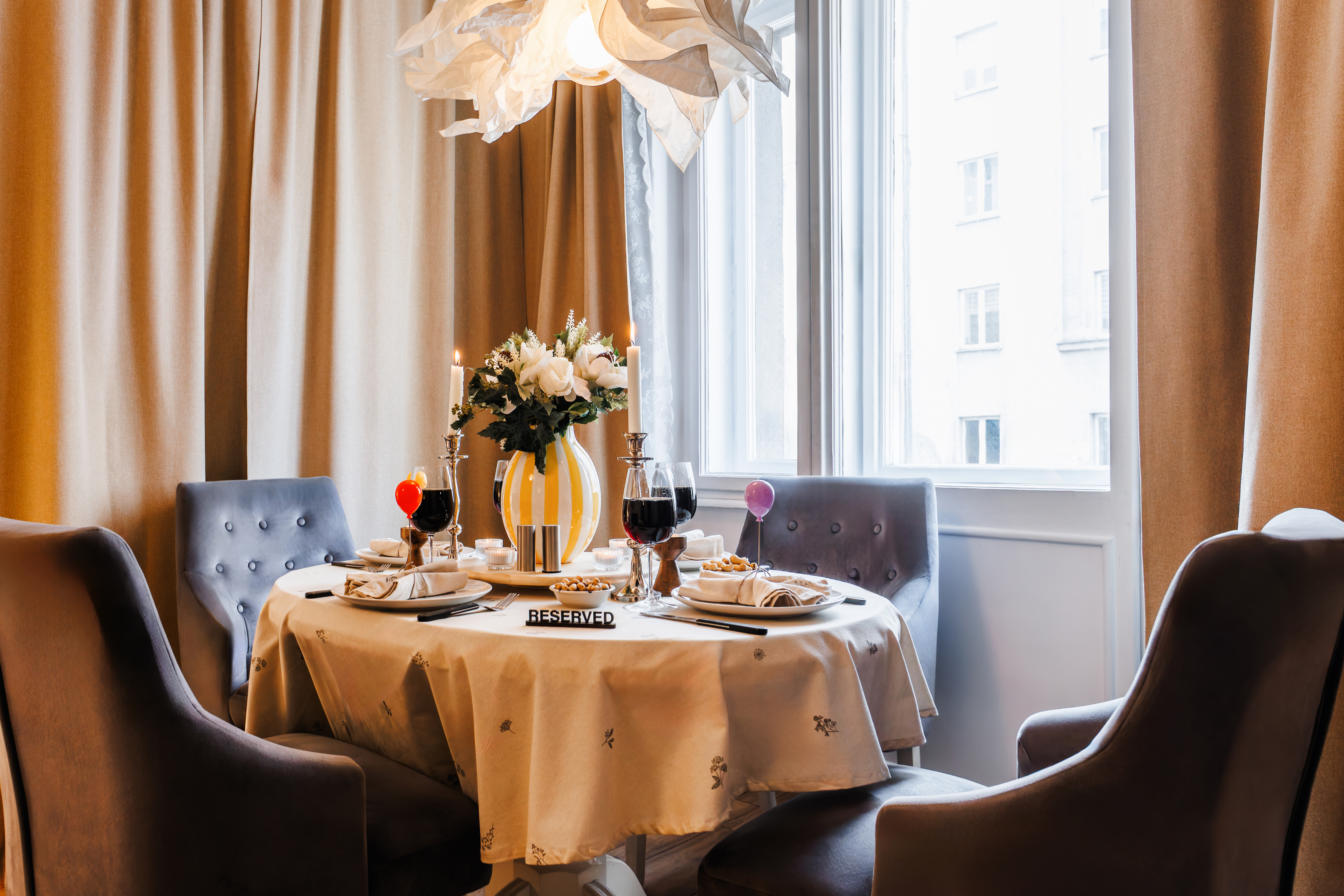 Elegant dining nook with natural light and a beautifully set table for four