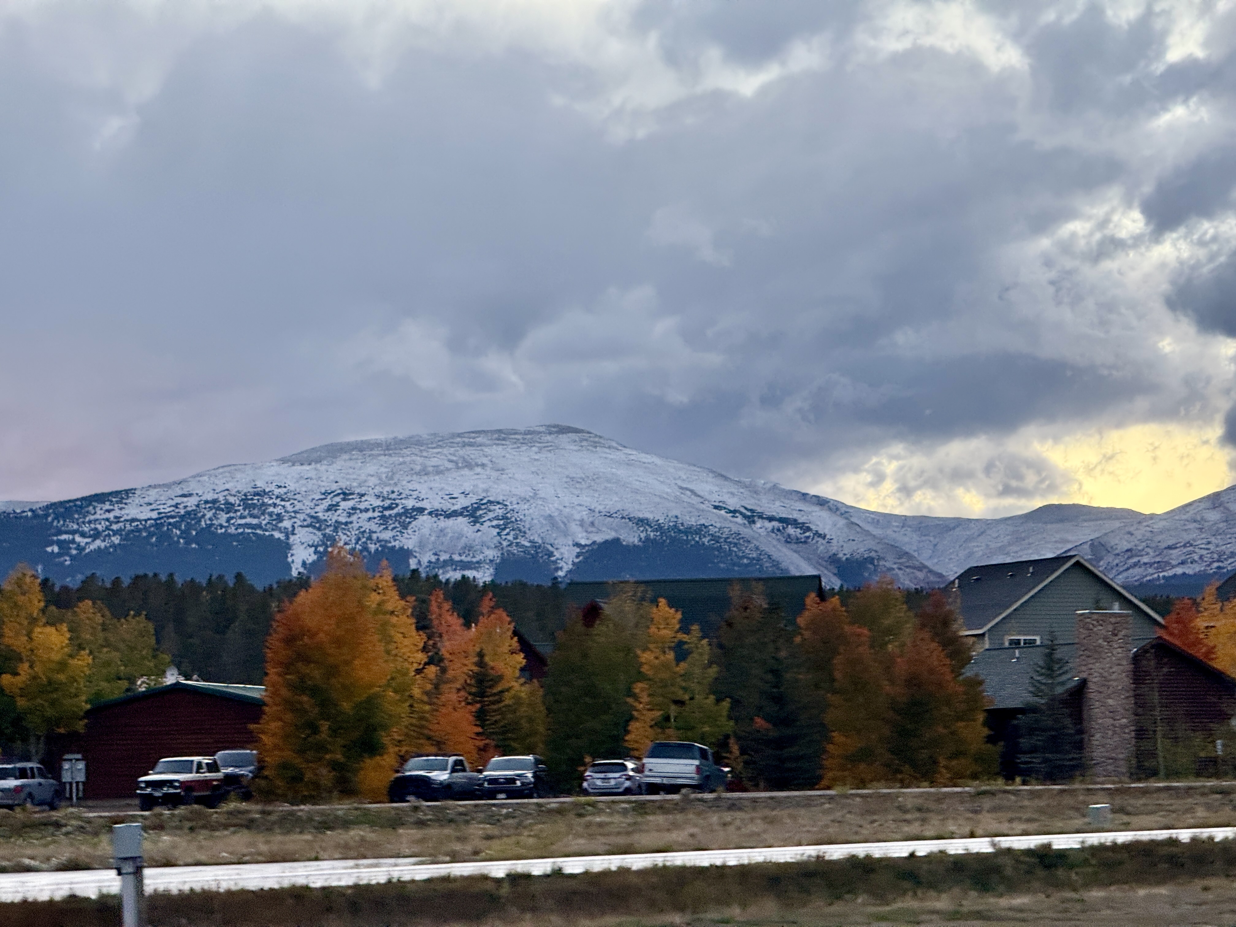 Snow-capped mountain views framed by vibrant autumn colors