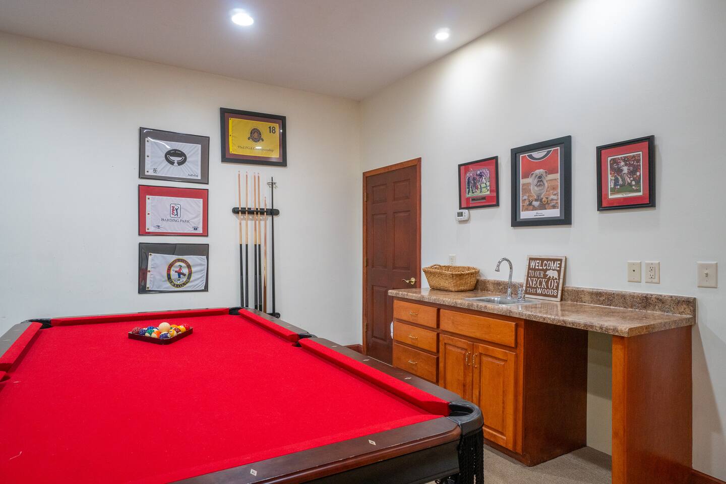 Pool table in the basement with wet bar