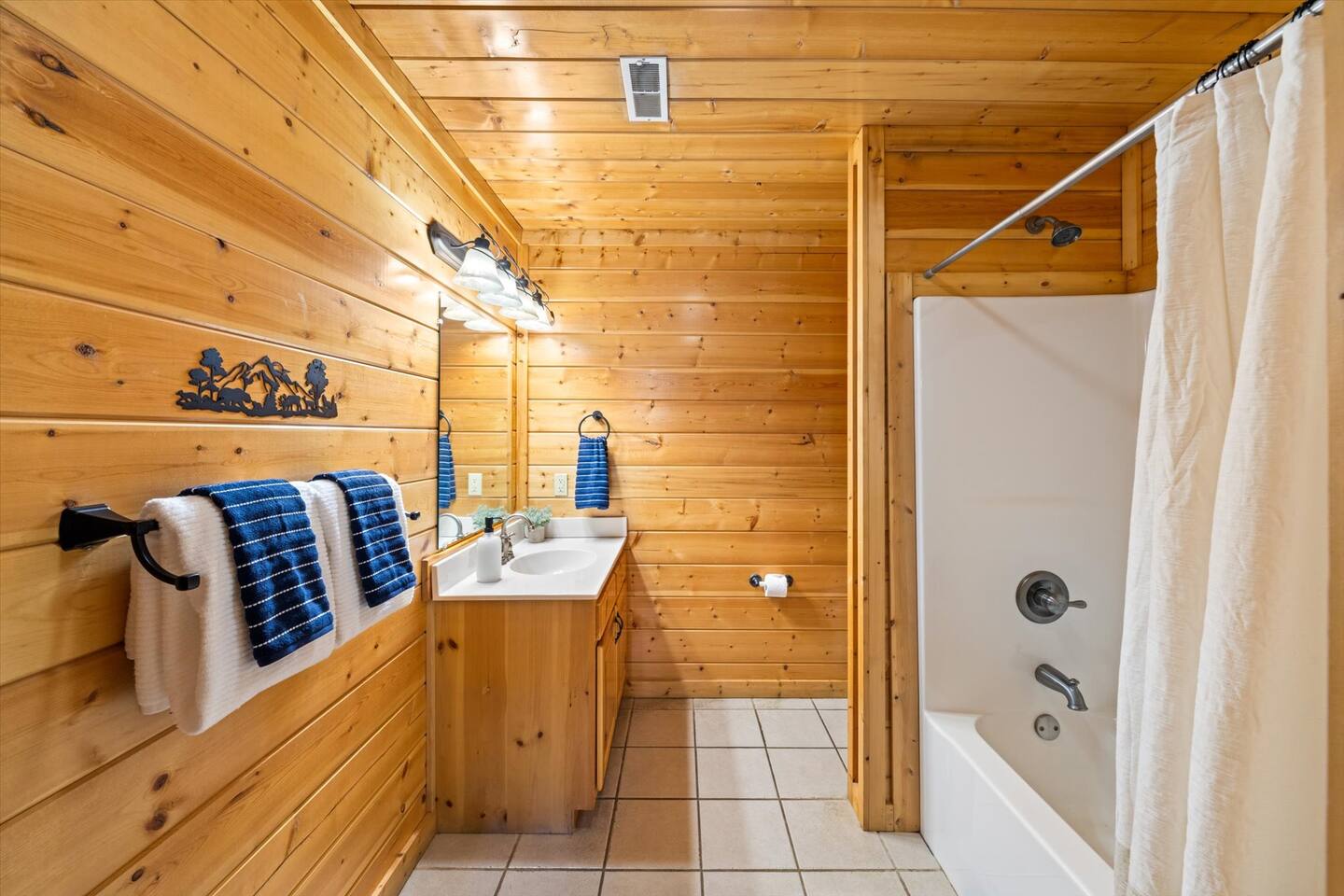 Bathroom with tub shower & vanity off the king bedroom on the 1st floor