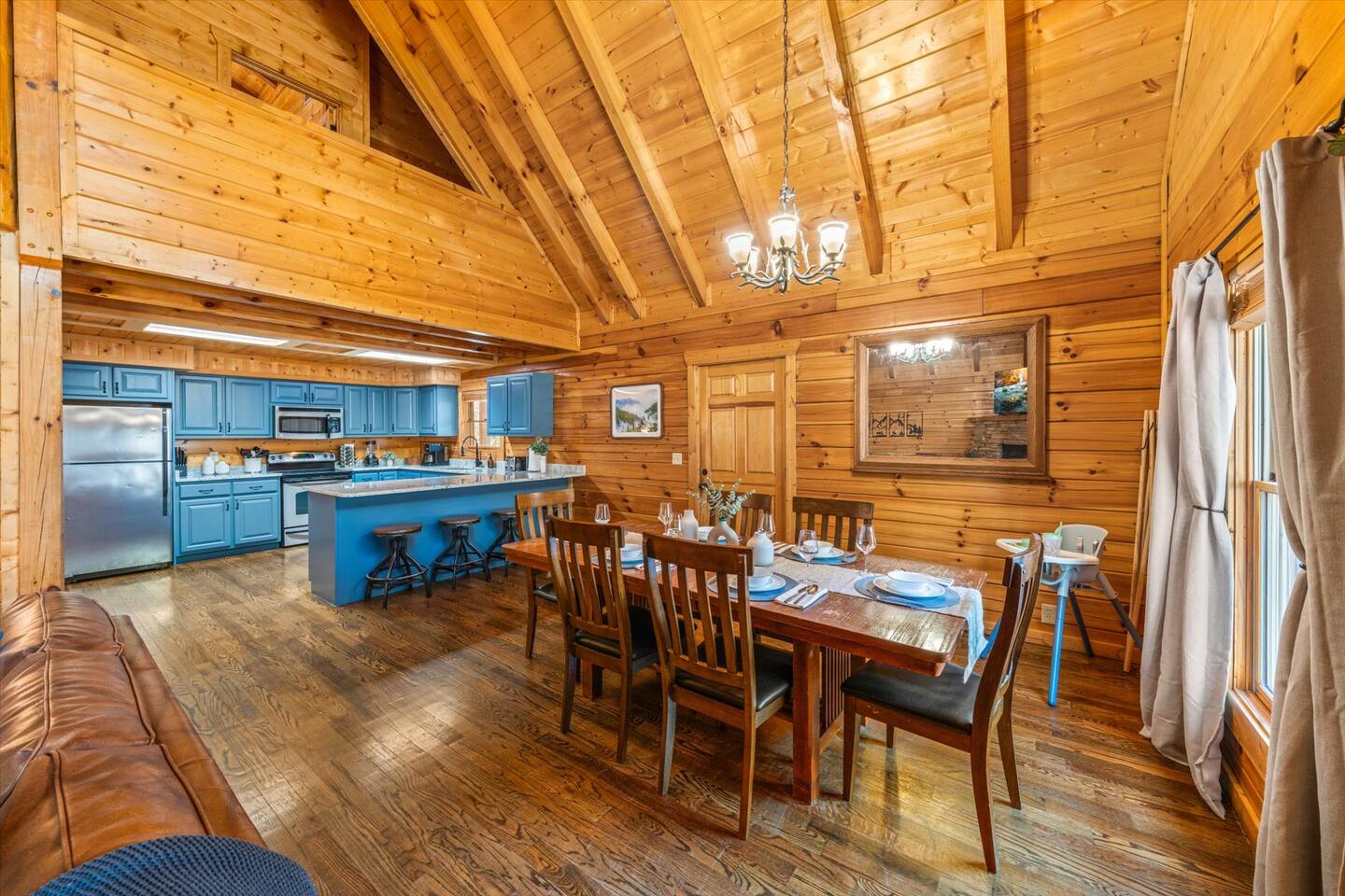 Large dinner table, additional bar seating, and a high chair