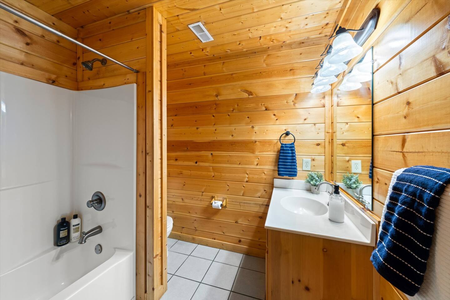 Bunk room bathroom with tub shower and vanity