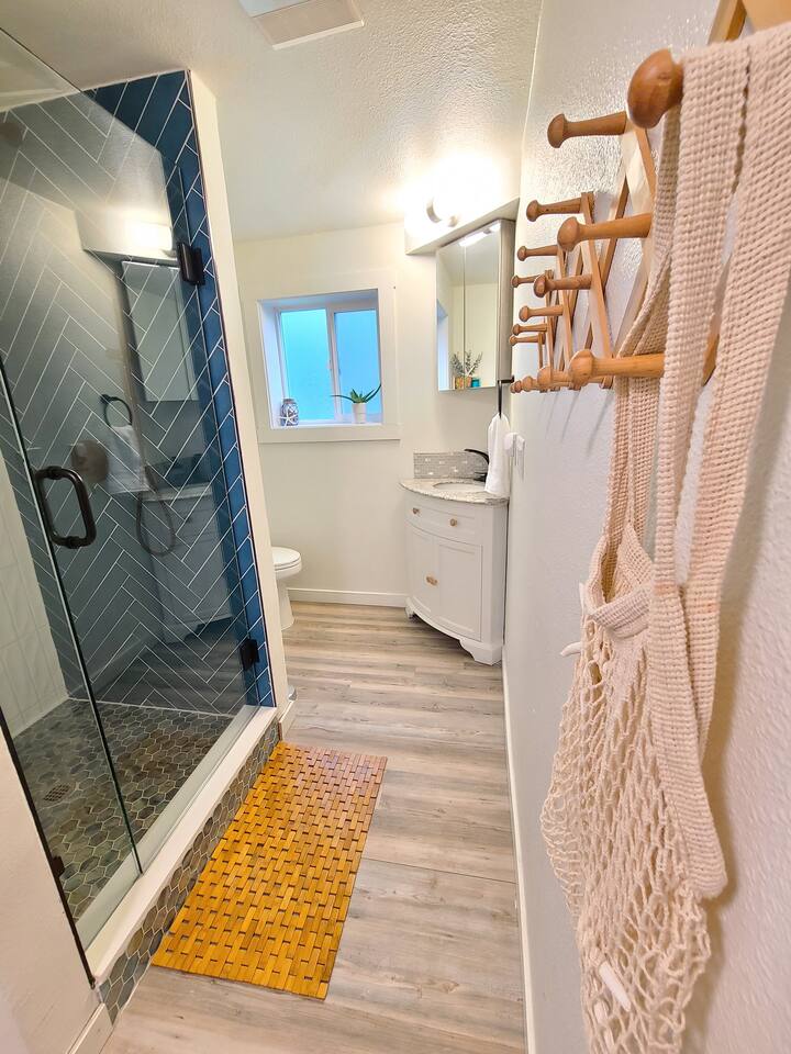 Bright and modern bathroom with a spacious glass-enclosed shower, a great place to clean up after a long day!