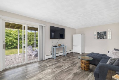 Downstairs Living Area with Second refrigerator and slider to backyard.