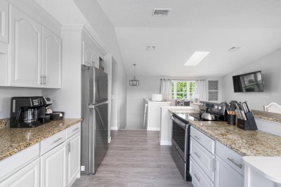 Open Kitchen into Living Room with Stairs to Lower Level