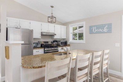 Kitchen with all modern appliances. Refrigerator, Dishwasher, Toaster, Coffee Maker, Microwave and more.