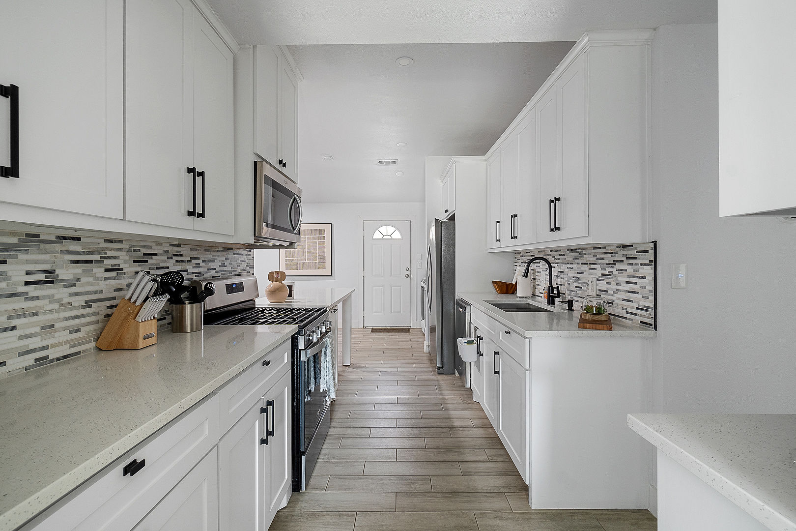 Bright modern kitchen with quartz counters and stainless appliances