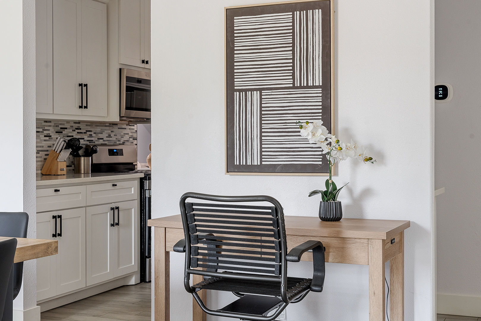 Bright modern workspace beside a stylish, updated kitchen