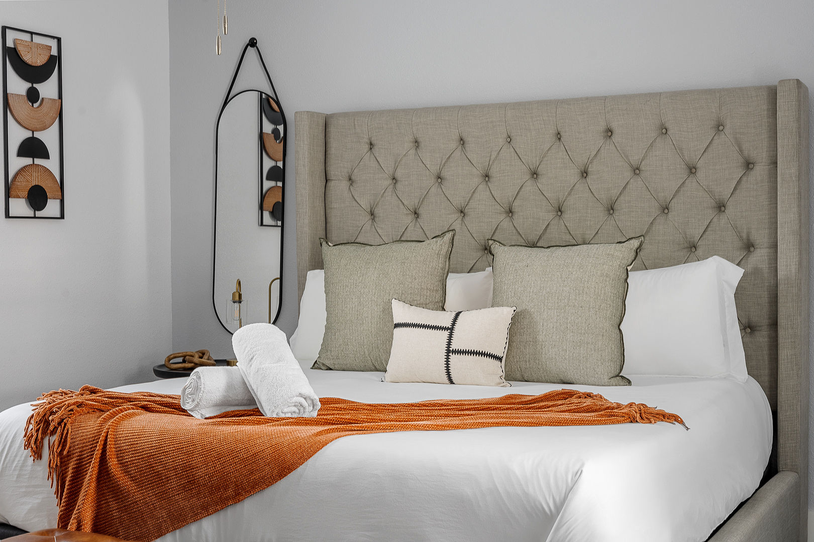 Elegant bedroom with tufted headboard and cozy designer touches