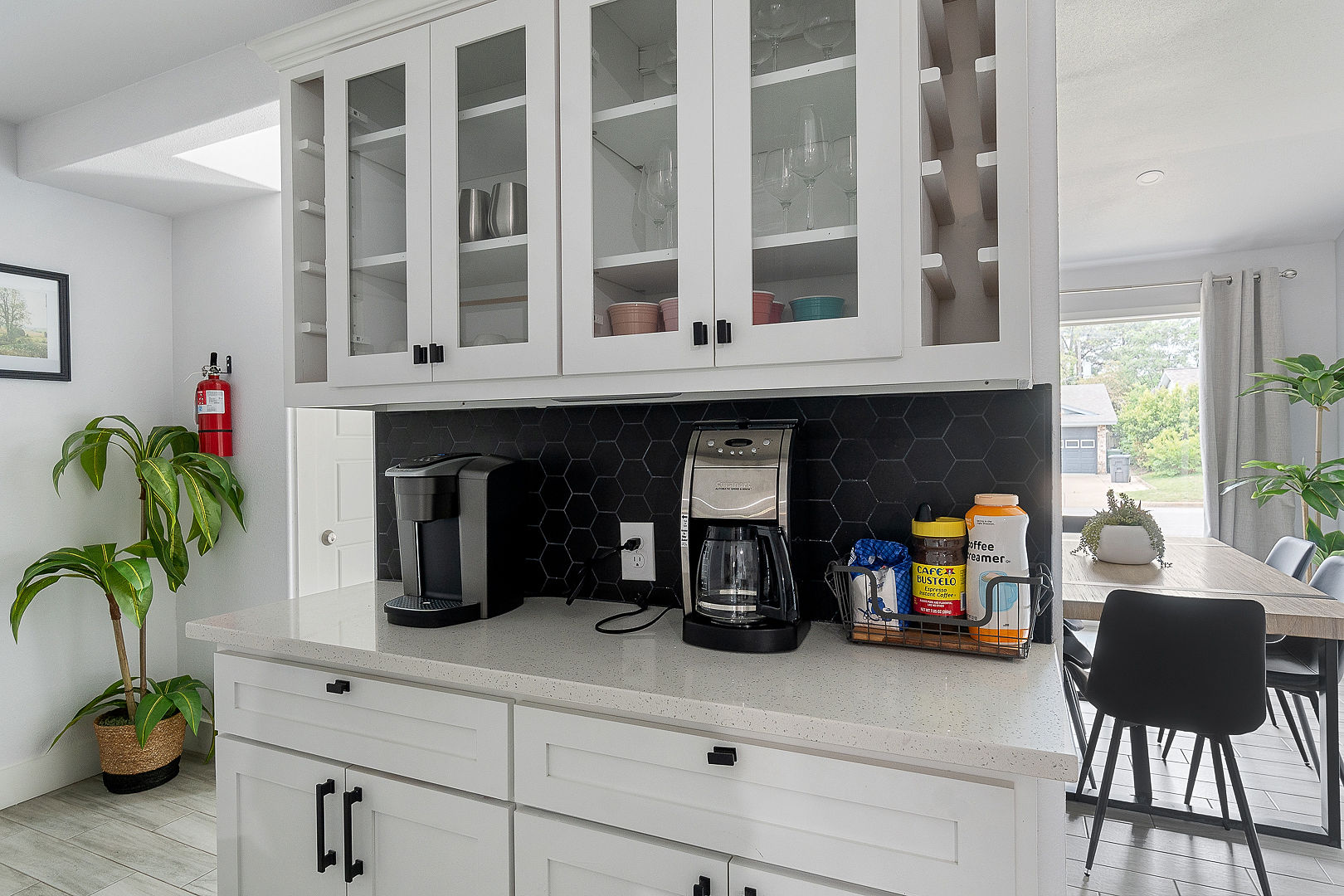 Modern kitchen coffee station with bright dining area access