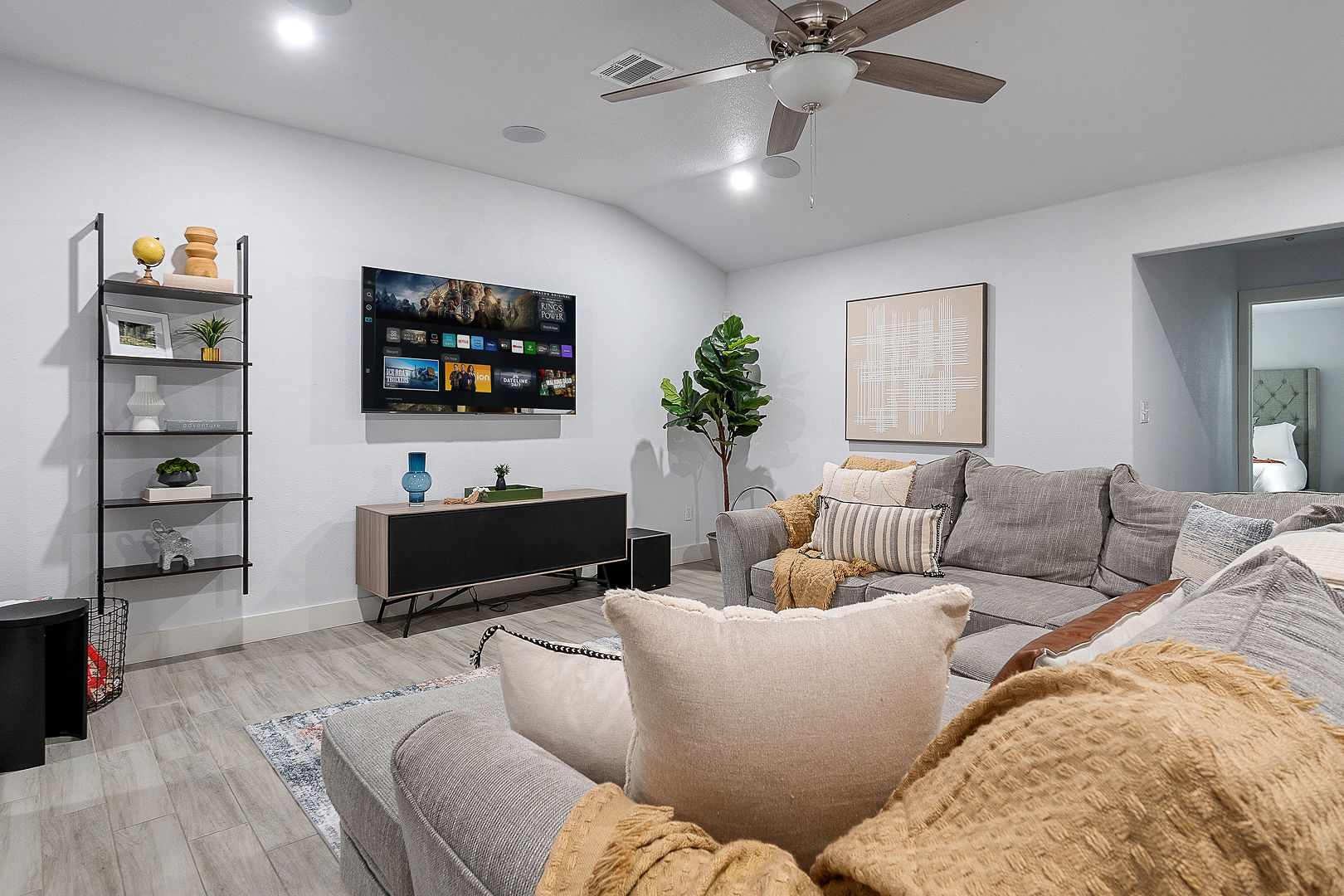 Bright modern living room with sectional sofa and smart TV