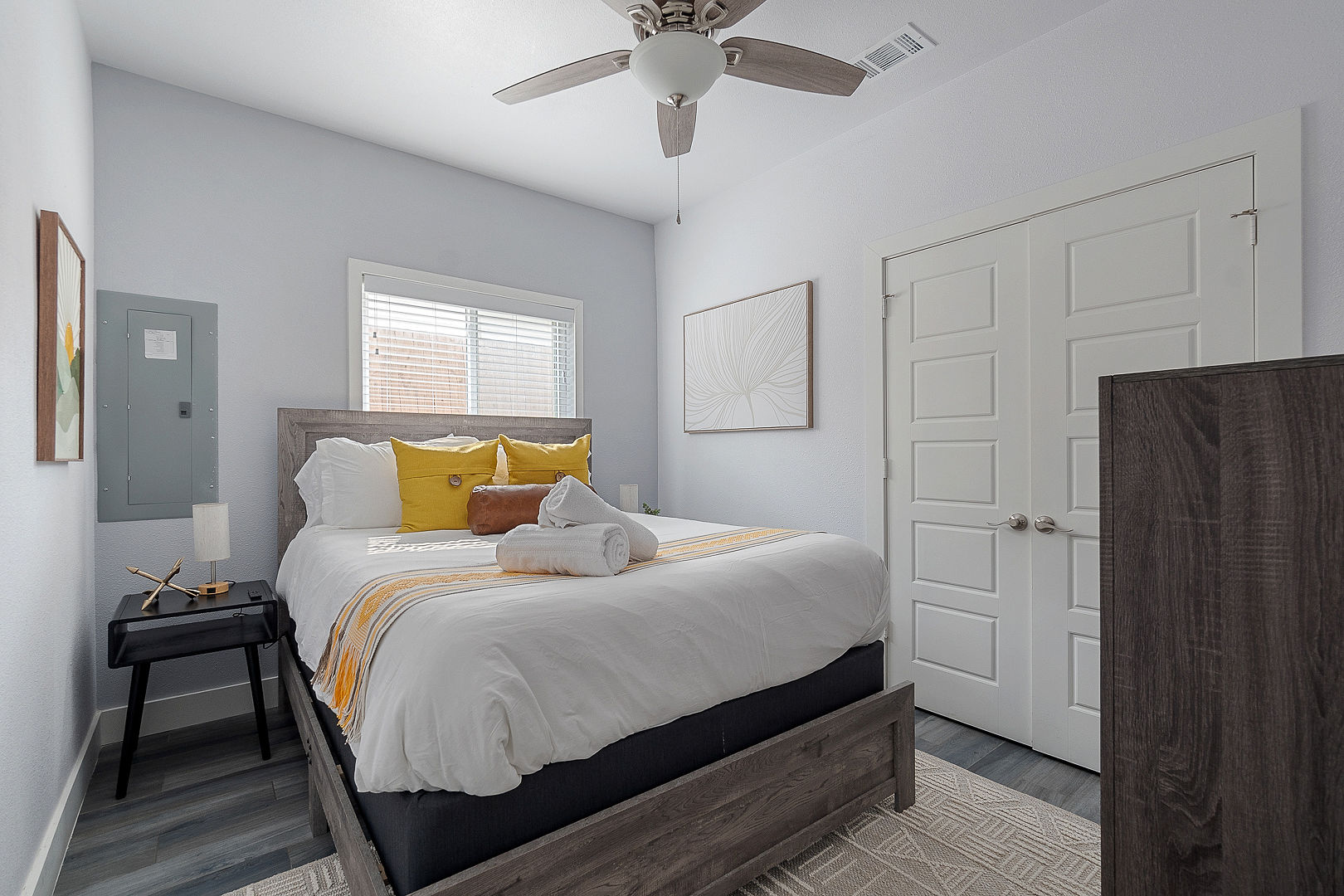 Bright modern bedroom with cozy linens, natural light, and stylish décor