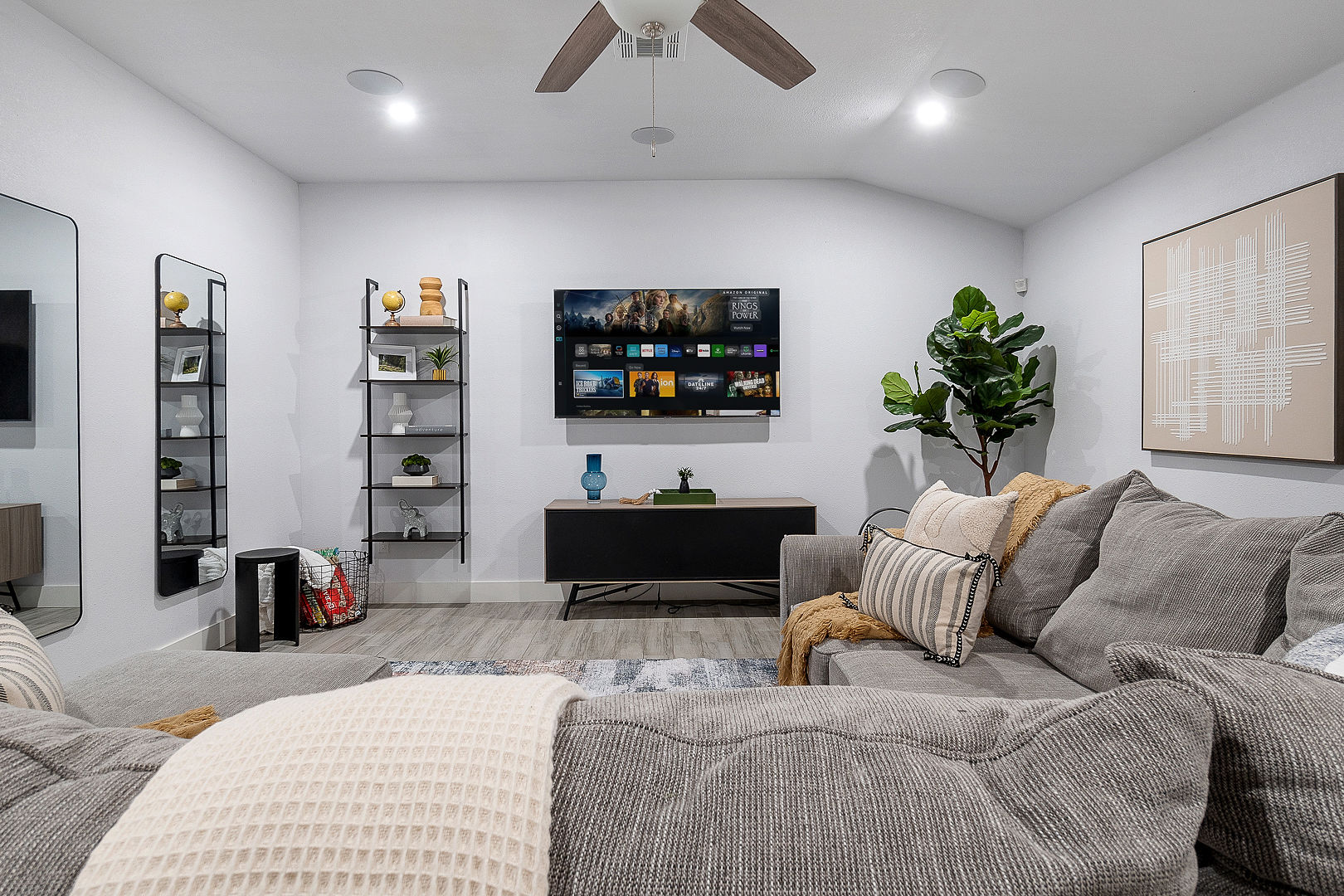 Cozy modern living room with large sectional and wall-mounted TV
