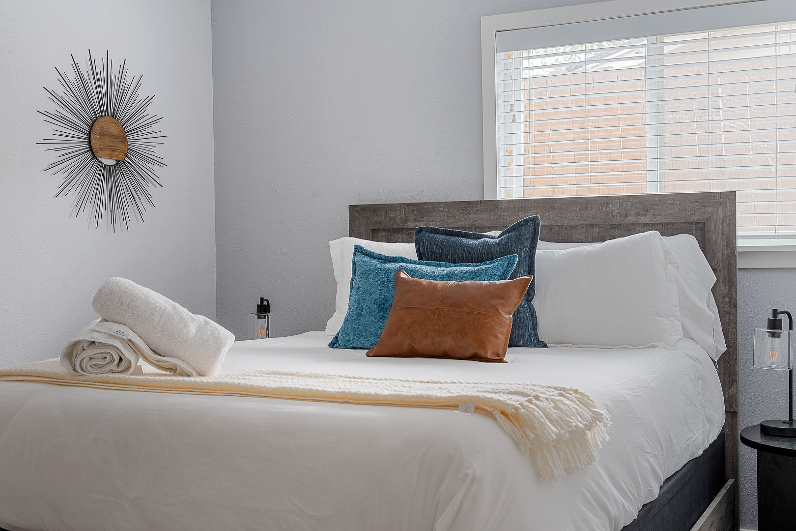 Bright, modern bedroom with plush linens and stylish decor