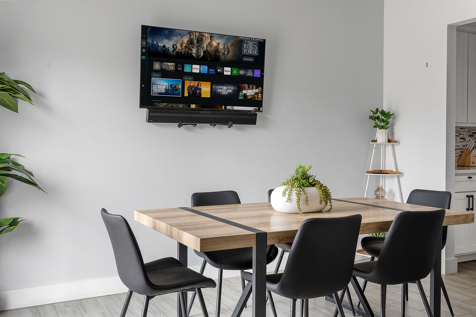 Modern dining space with smart TV, stylish seating, and fresh decor