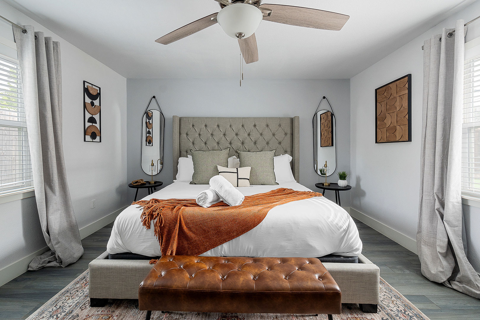 Bright, stylish king bedroom with designer touches and cozy seating