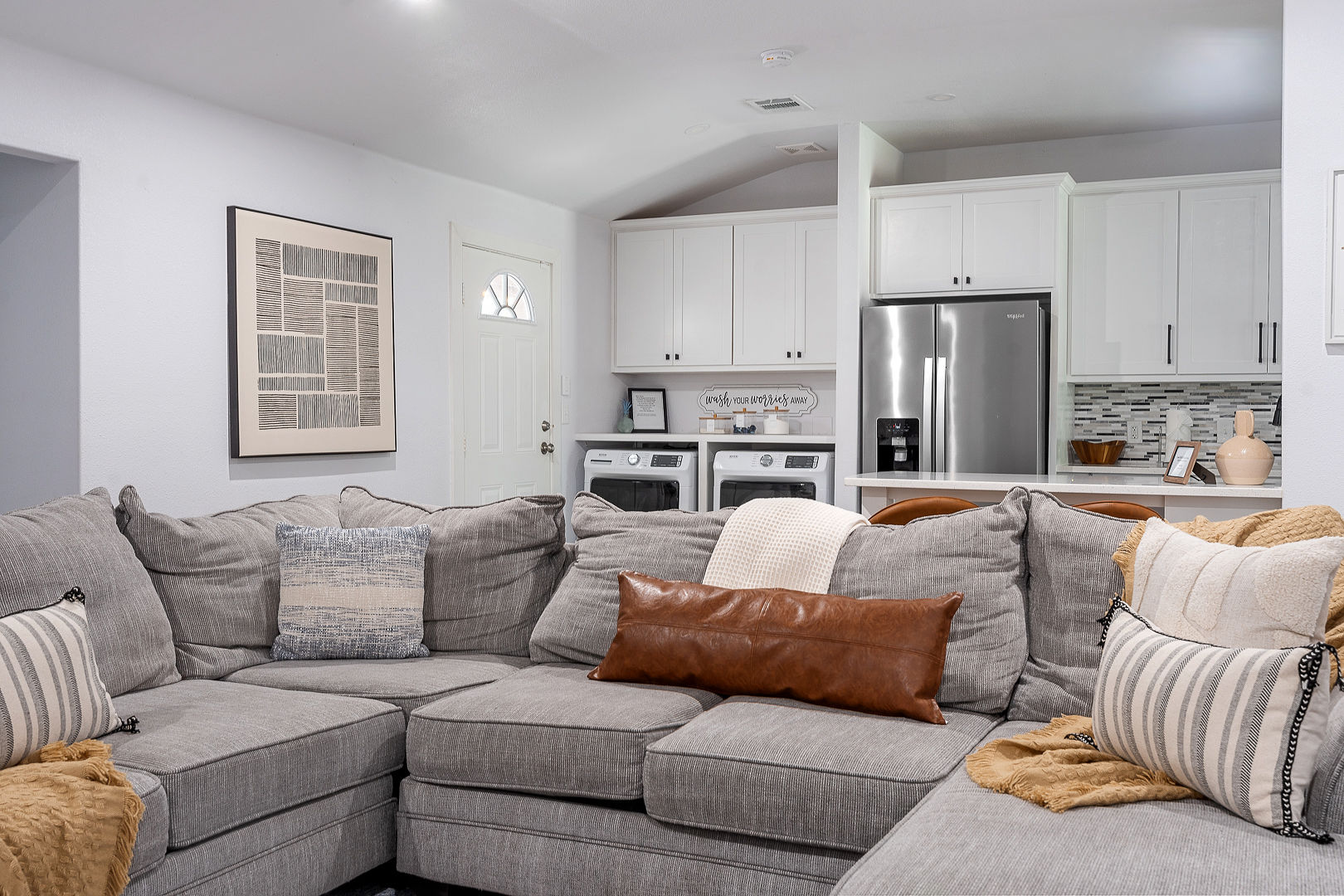 Cozy sectional lounge with modern kitchen and bright open layout