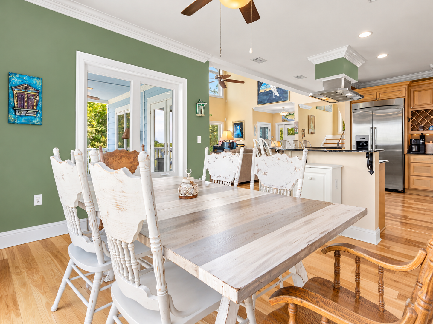 Bright farmhouse dining area with open kitchen and French doors