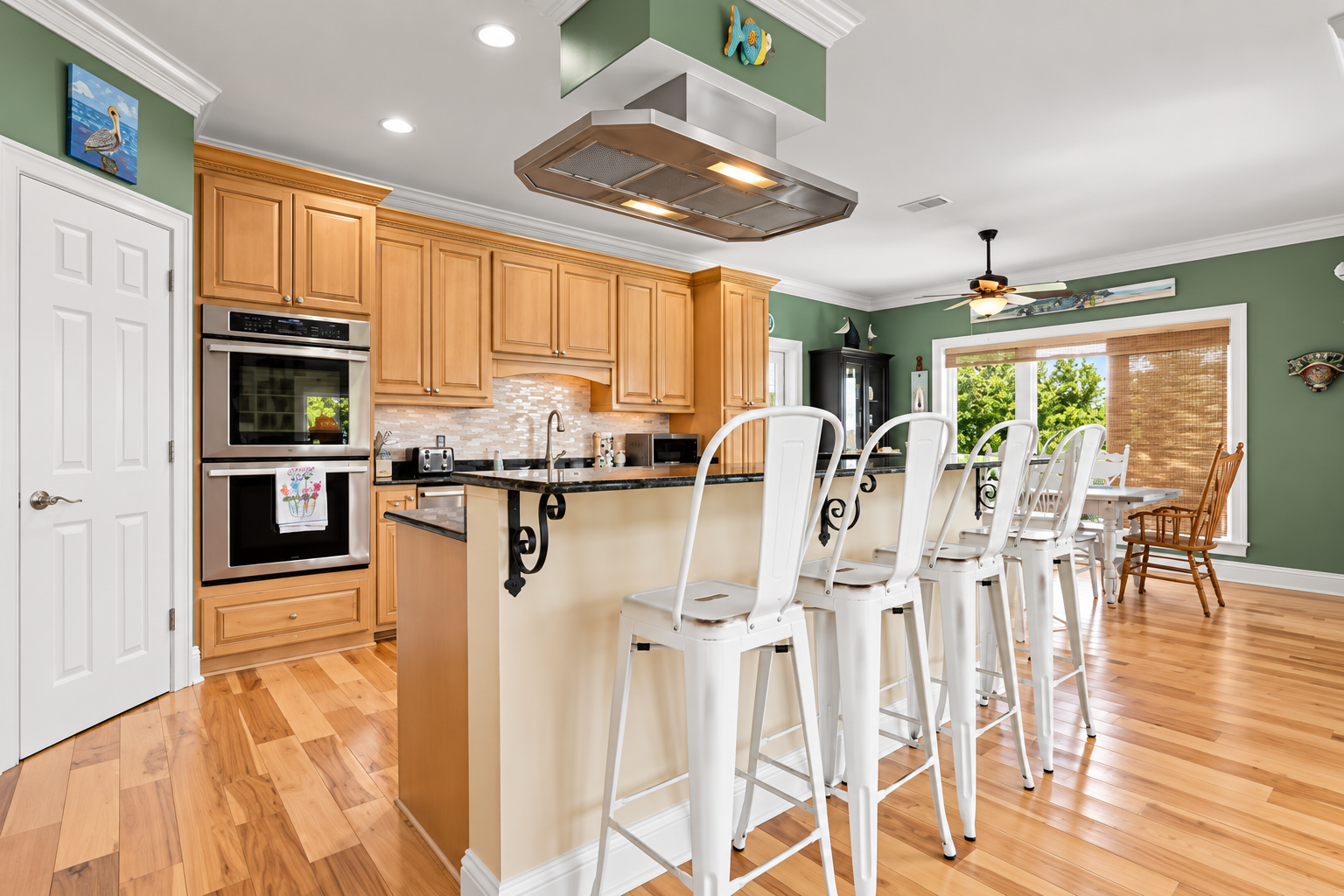 Bright open kitchen with large island seating and sunny dining space