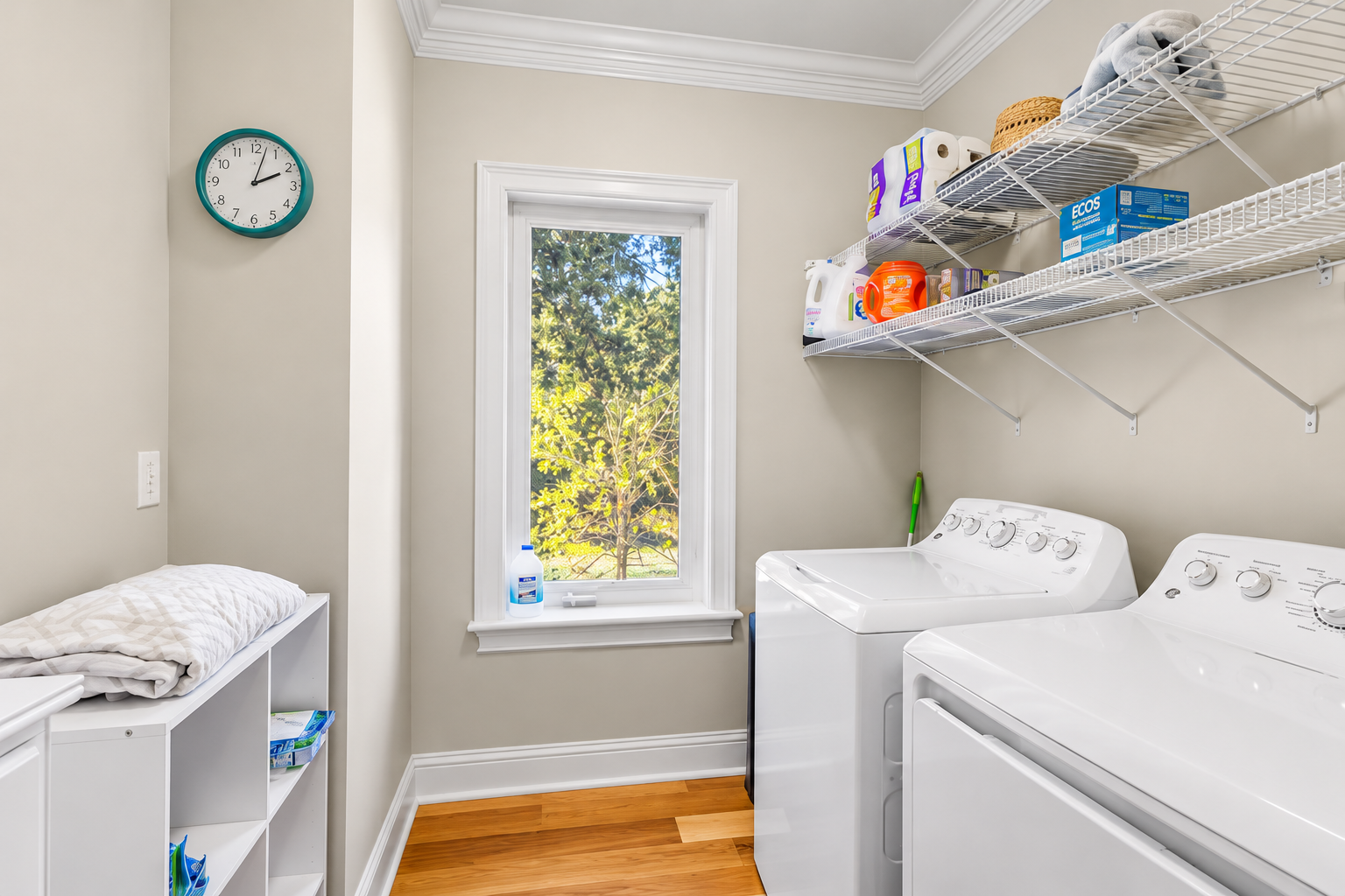 Bright laundry room with full-size washer/dryer and natural light