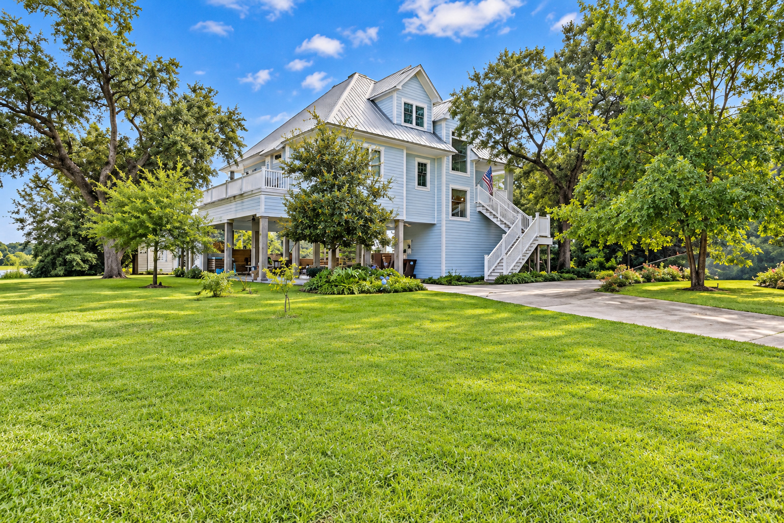 Spacious elevated home with lush lawn, mature trees, and inviting outdoor space