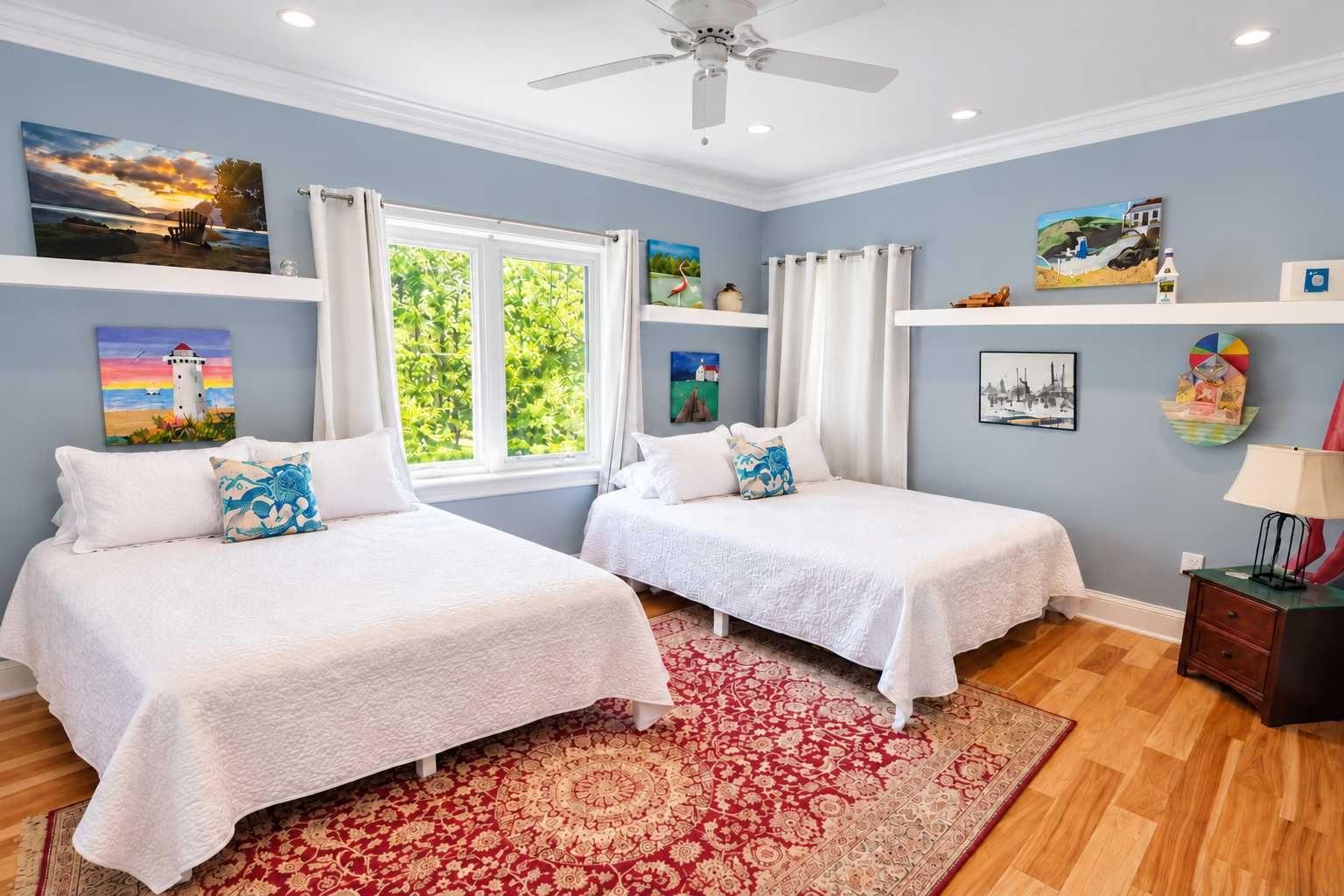 Bright coastal-style bedroom with two beds, natural light, and cheerful decor