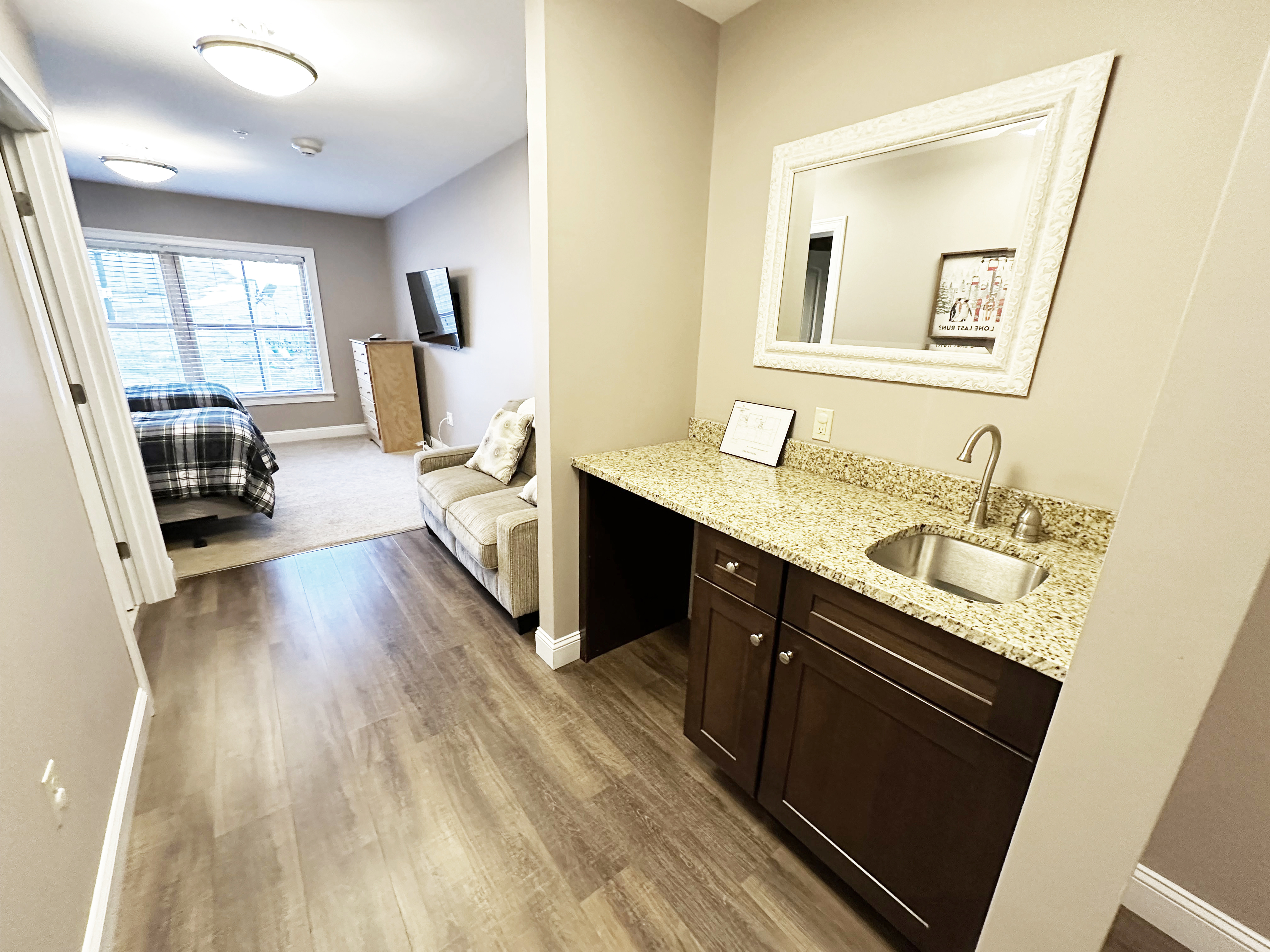 2nd bedroom suite includes small sink and sitting area