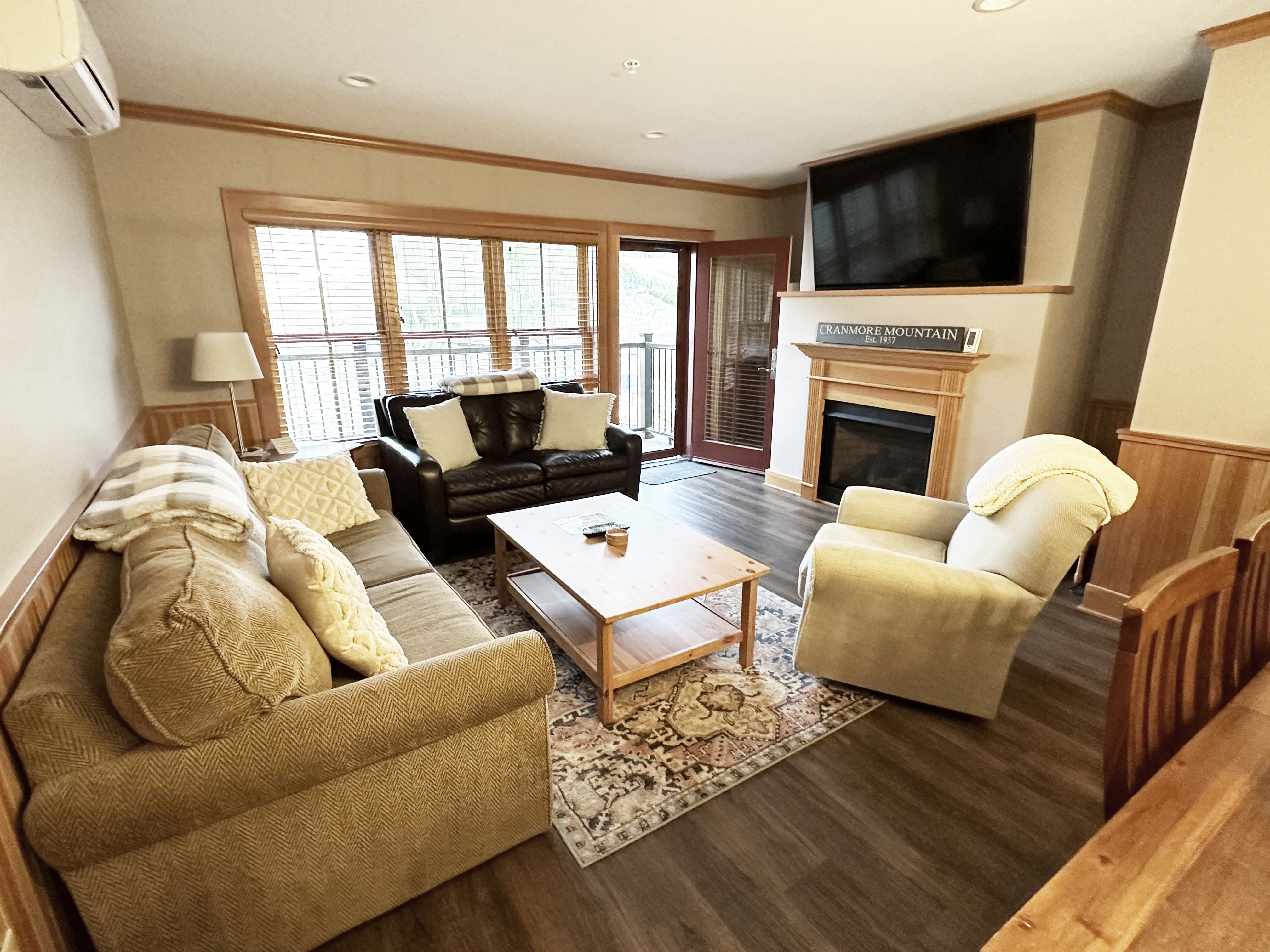 Living room has porch access with views of Cranmore Mountain