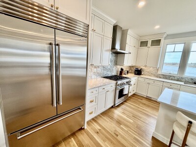 Bright luxury kitchen with stainless appliances and scenic water views