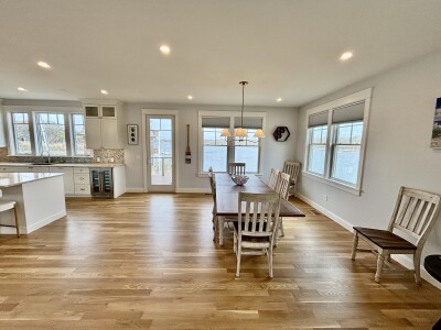 Bright open dining area with modern kitchen and plenty of natural light