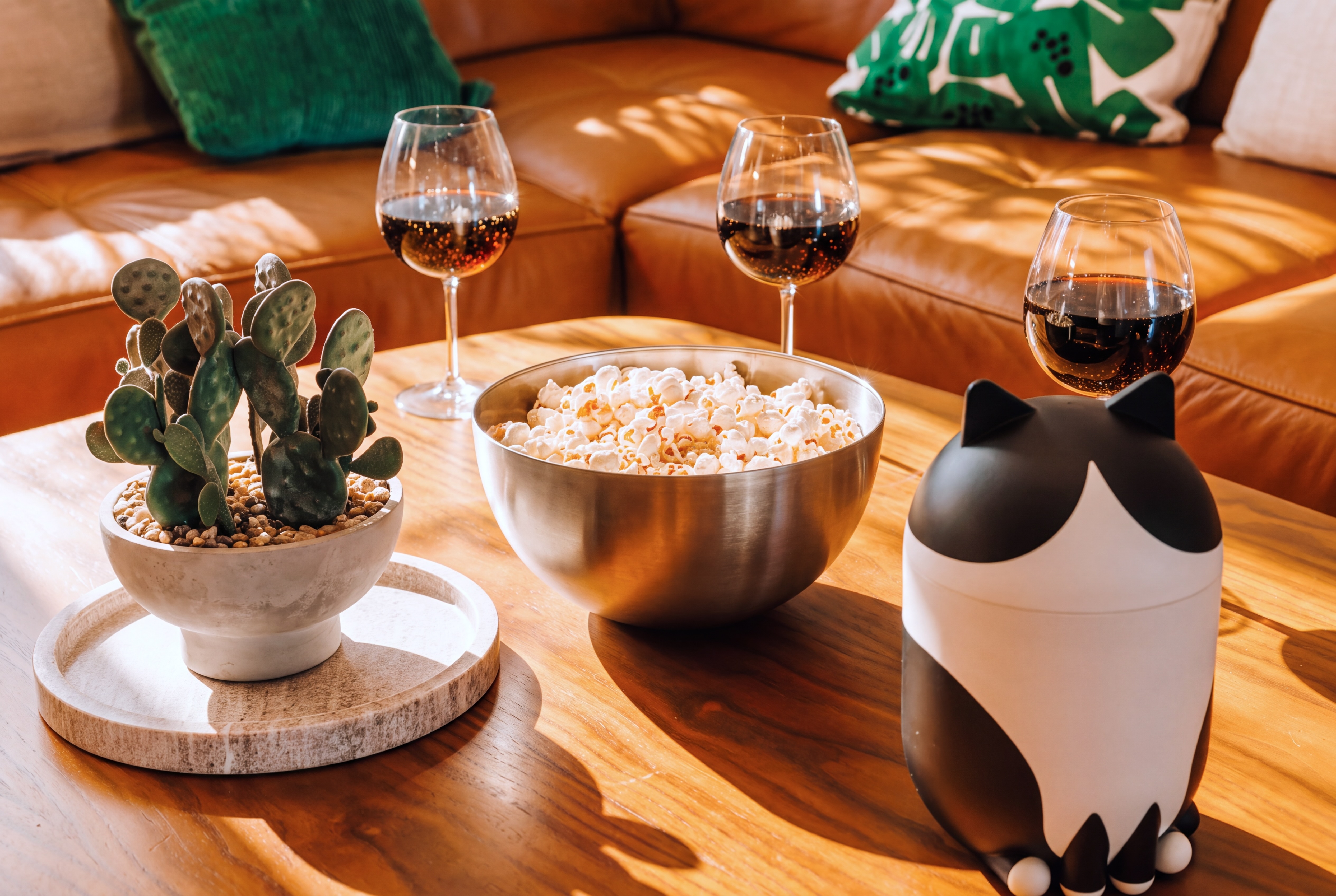 Cozy sunlit lounge with wine, popcorn, and stylish leather seating
