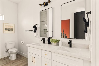 ✨ Modern full bathroom with dual-sink vanity, sleek black fixtures, and spacious shower. Bright, clean design with stylish mirrors and storage. Perfect for getting ready, refreshing, or unwinding during your stay.