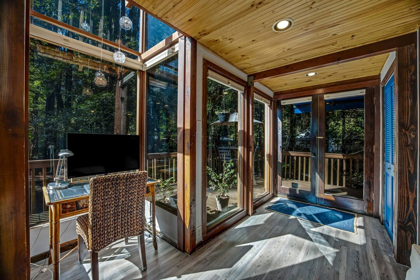 A peaceful nook to work, where the forest greets you through every window.