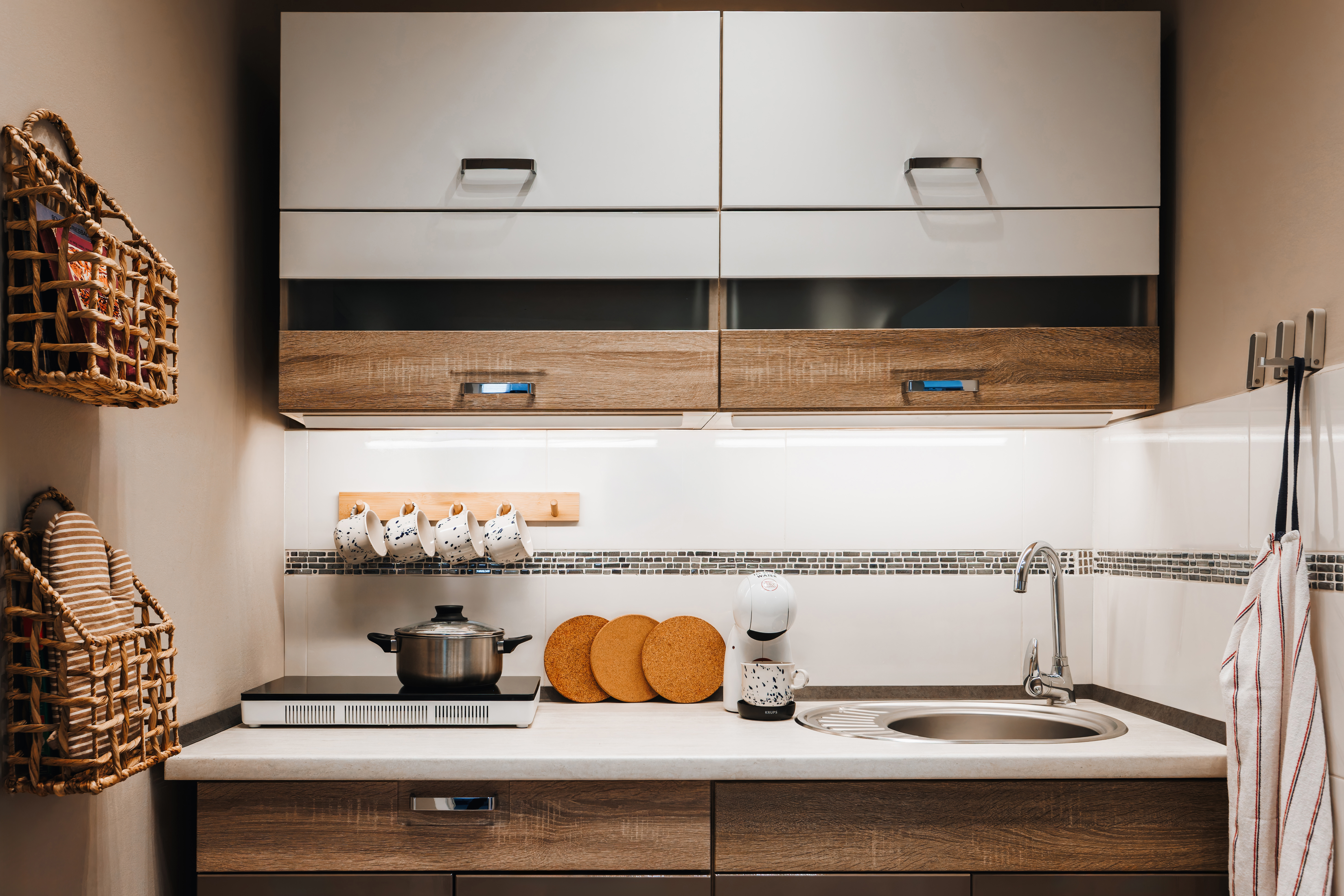 Modern kitchenette with coffee station and stylish wood cabinetry