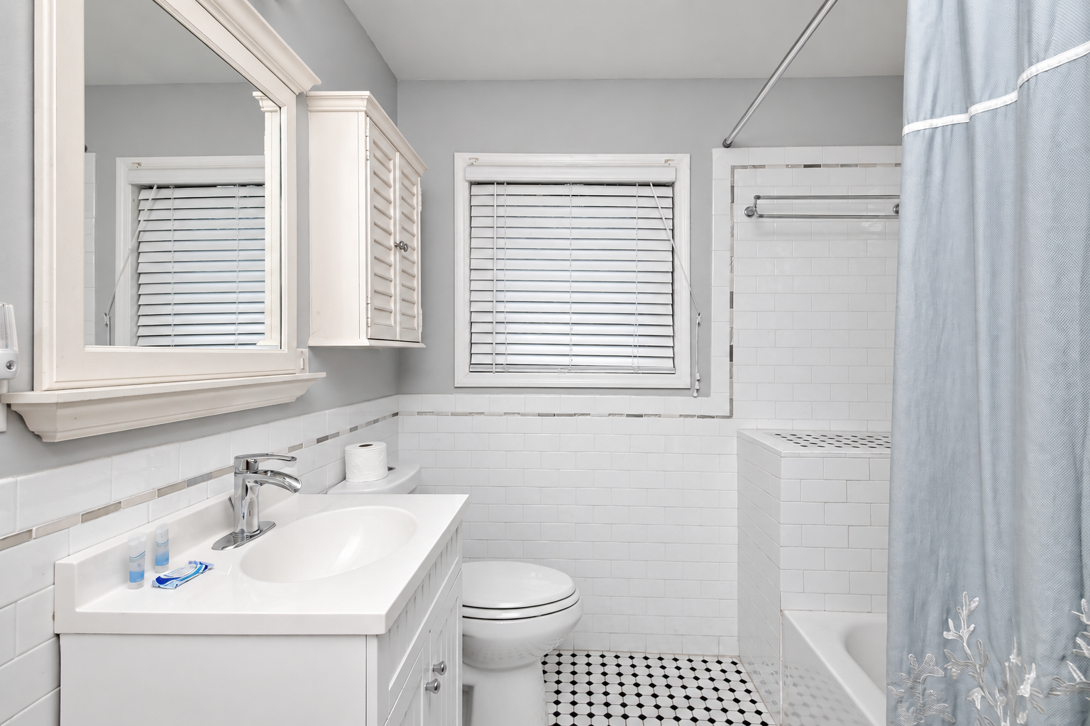Bright, updated bathroom with tub-shower and crisp modern finishes
